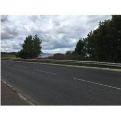 Photograph looking across a road towards the three bridges