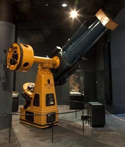 The large black and yellow Schmidt camerascope on display at the National Museum of Scotland