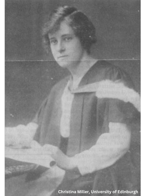 Old black and white photo of a woman with short dark hair and dark eyes wearing a graduation gown and holding a diploma. 