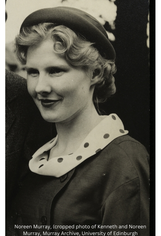 A sepia head-and-shoulders photo (circa 1950s or 1960s) of a smiling woman with light curls under a dark hat, wearing a dark coat with a white polka dot collar. 