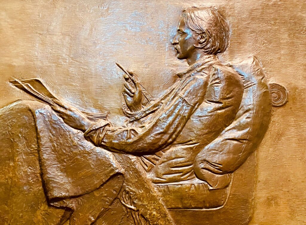 Close-up of reclined man writing, profile view.