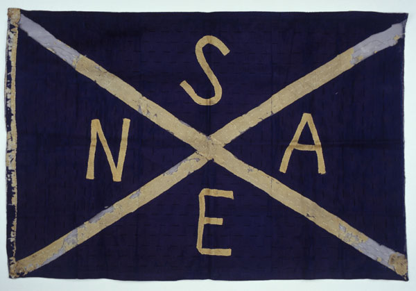 White-ish X across a navy background in the style of Saltire with letters in each section reading SNAE. 